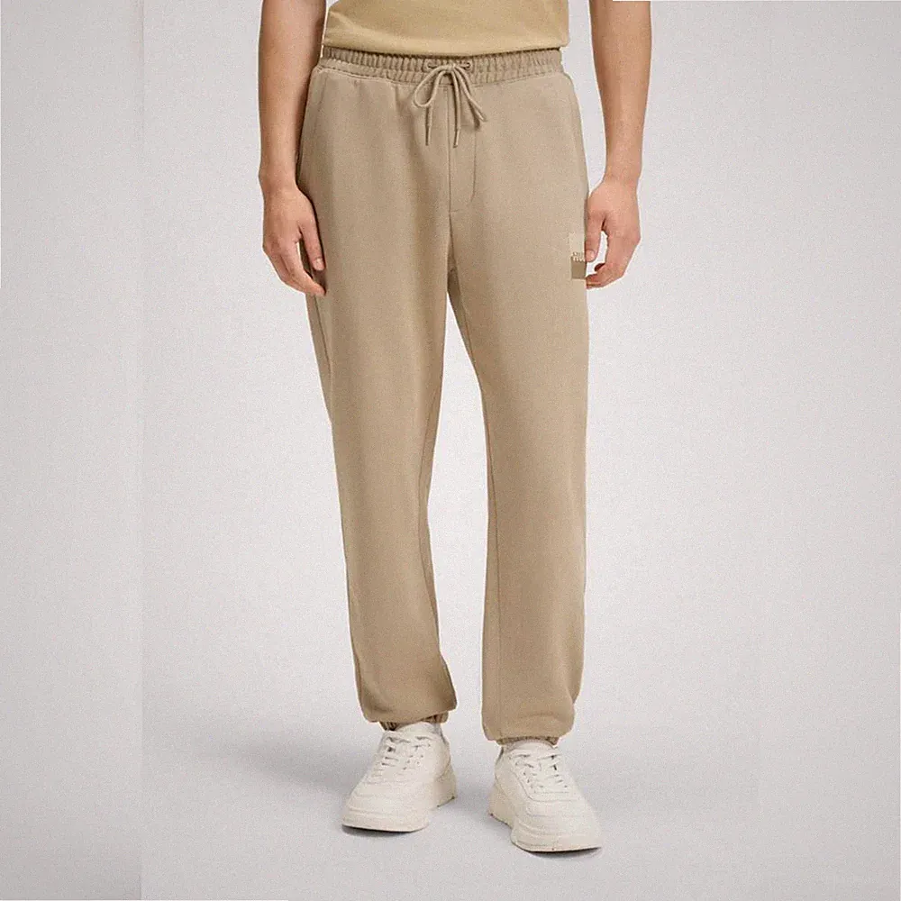 HUGO BOSS Jogginghose (EU: M) aus Baumwoll-Terry mit Split-Logo, Beige
