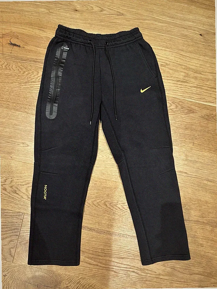Nike NOCTA Herren Jogginghose XS schwarz/gelb mit Reißverschlusstasche Zugband