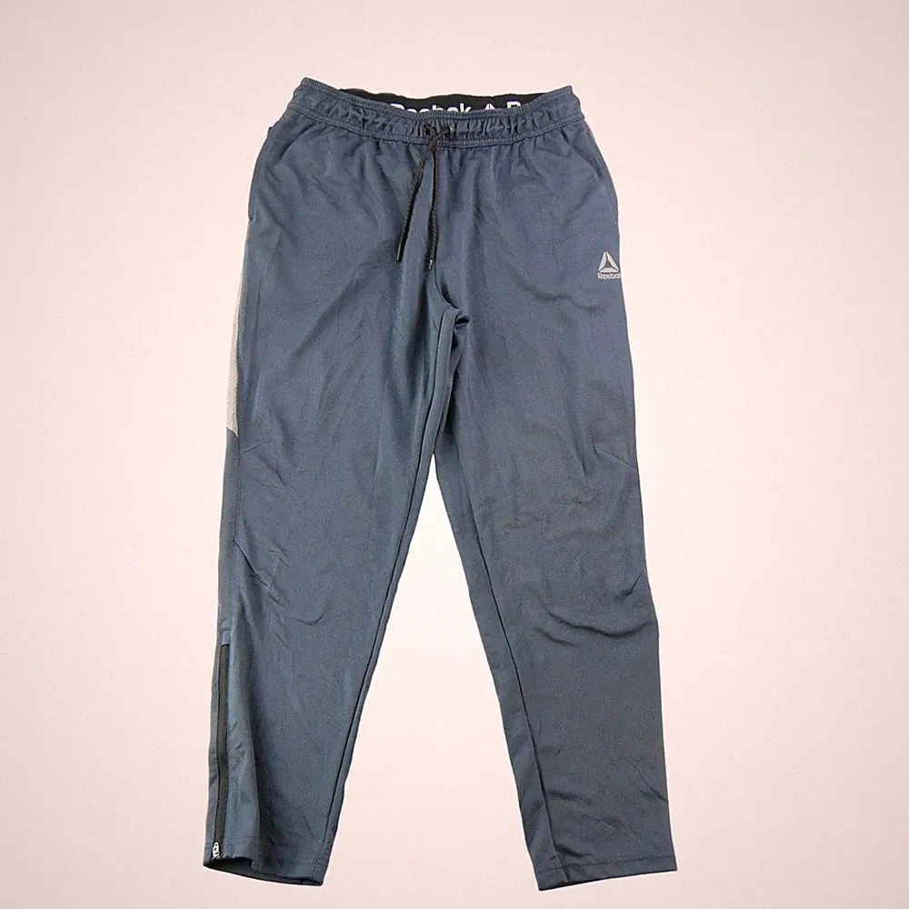 Reebok Jogginghose Regular Fit Rusel Woven Einsätze Mesh Strümpfe Reißverschlusstasche Arri